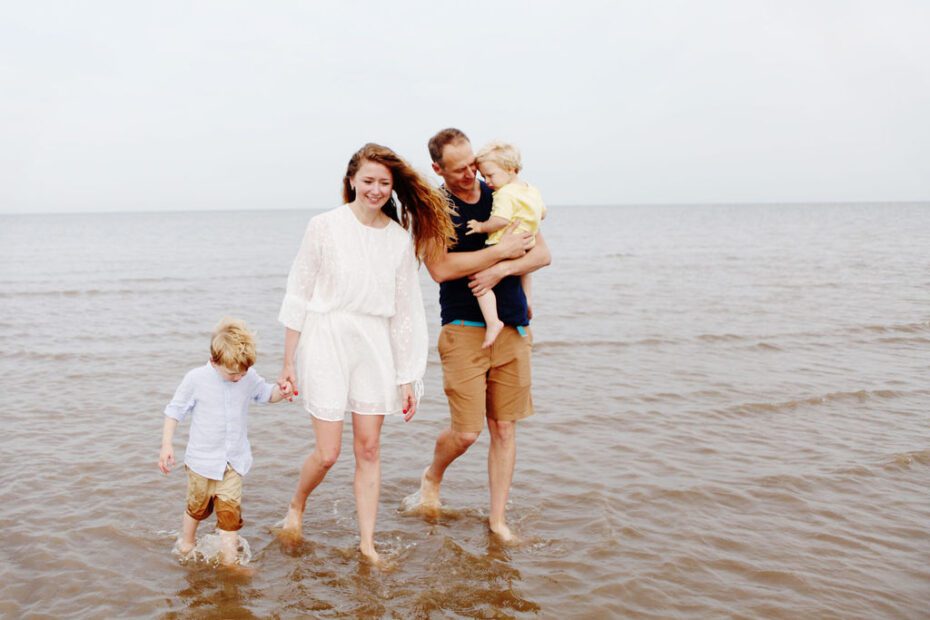 family photography - family walking on shallow part of the sea water