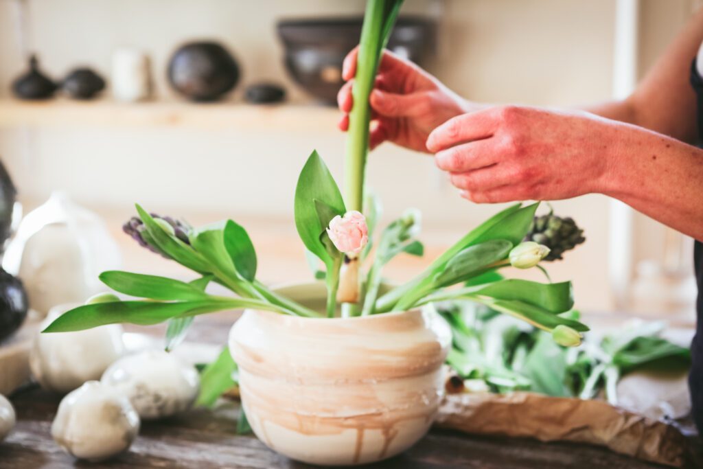 brand photography with a potter arranging flowers